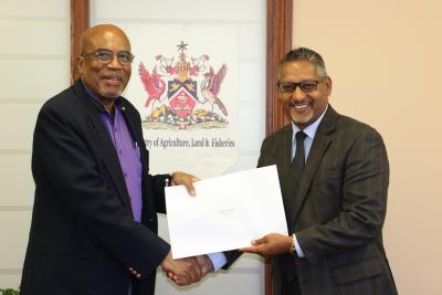 Senator the Honourable Clarence Rambharat, Minister of Agriculture, Land and Fisheries (right), is all smiles as he confers the Chairman of the Agricultural Development Bank (ADB), Mr. Winston Rudder, with his instrument of appointment at a brief ceremony held at his Ministry’s corporate headquarters in Chaguanas on Wednesday 29th November, 2017.