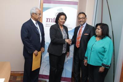 Caption: Minister of Trade, Industry, Investment and Communications, Senator the Honourable Vasant Bharath, congratulates newly appointed Chairperson Justice Amrika Tiwary-Redd. Looking on are Dr. Anne Marie Mohammed (right) and Dr. Ronald Ramkissoon (left), Fair Trading Commissioners. (Photo courtesy the Ministry of Trade, Industry, Investment and Communications)