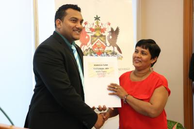 Parliamentary Secretary in the Ministry of Agriculture, Land and Fisheries, Senator Avinash Singh, assists in the distribution of an agricultural lease at the Ministry’s corporate headquarters in Chaguanas on Tuesday 9th January, 2018. The gesture formed part of an Agricultural Lease Distribution Ceremony held for a total of forty-seven (47) former VSEP workers of Caroni (1975) Limited.