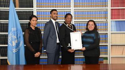 From left: Ms. Charlene Roopnarine, First Secretary, Permanent Mission of Trinidad and Tobago to the United Nations, New York; Mr. Vladamir Budhu, Second Secretary, Permanent Mission of Trinidad and Tobago to the United Nations, New York; Her Excellency Pennelope Beckles, Permanent Representative of Trinidad and Tobago to the United Nations, New York; and Ms. Dina Hamdy, Legal Officer, Office of Legal Affairs Treaty Section, United Nations, New York display Trinidad and Tobago’s Instrument of Ratification to the Paris Agreement.