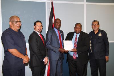 Caption: Prime Minister, Dr. the Honourable Keith Rowley (c) receives a Petrotrin report from Selwyn Lashley, Chairman of the Petrotrin Review Committee and Permanent Secretary, Ministry of Energy and Energy Affairs. On hand for the presentation are from left: Gregory Marchan, Representative of the OWTU, the Honourable Stuart Young, Minister in the Office of the Prime Minister and Minister in the Office of the Attorney General and Legal Affairs and David Abdullah, Representative of the OWTU. (Photo courtesy the Office of the Prime Minister)