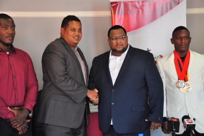 Caption: Minister of Sport and Youth Affairs, the Honourable Darryl Smith (2nd from left) shakes hands with Jason Fraser, President of the Trinidad and Tobago’s Sambo Federation (2nf from right), at the Ministry’s Head Office, Abercromby Street, Port of Spain. (Photo courtesy Ministry of Sport and Youth Affairs)