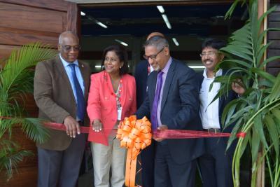 Senator the Honourable Clarence Rambharat, Minister of Agriculture, Land and Fisheries cuts the ribbon and declares the Exhibition open; along with (l-r) Professor Brian Copeland, PVC and Campus Principal, University of the West Indies, St Augustine; Senator the Honourable Paula Gopee-Scoon, Minister of Trade and Industry; and Professor Pathmanathan Umaharan, Director, Cocoa Research Centre, UWI, St Augustine