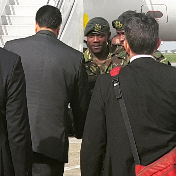 Venezuelan President (left) takes time out to greet a few members of the Trinidad and Tobago Regiment before proceeding to his waiting aircraft.
