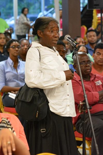 A member of the public expresses her concerns to the team of executives of WASA, TTPOST, SWMCOL, T&TEC and the Ministry of Public Utilities during the open forum at yesterday’s Public Outreach Programme