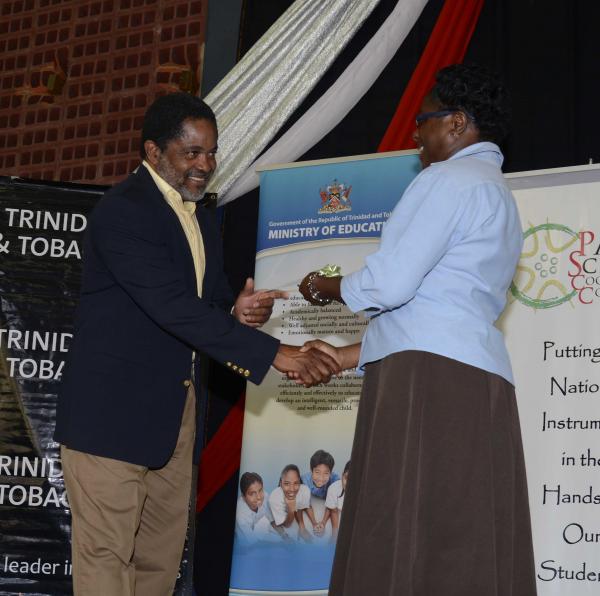Principal, San Fernando East Secondary School, Patricia Pitt (right) receives a cheque from Head, Social Performance BG Trinidad and Tobago, Leslie Bowrin.